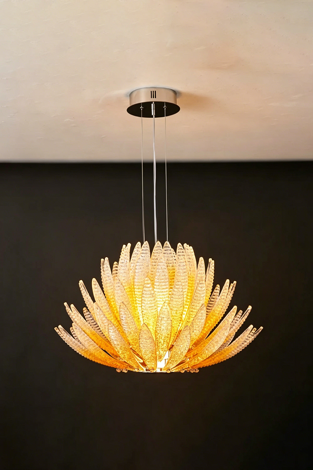 Helios Agave Glass Starburst Chandelier | Glass, Metal | Amber glass variant unlit against a black background, displaying the natural amber tint | Isolated shot | vexa lamps