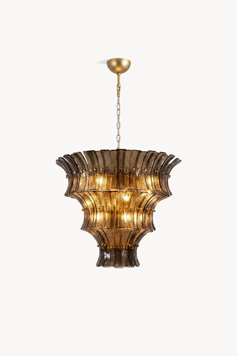 Octavia Sculptural Smoked Glass Chandelier | Studio Presentation | Clean front studio view of the tall tiered sculptural glass chandelier variant radiating a warm golden halo | vexa lamps