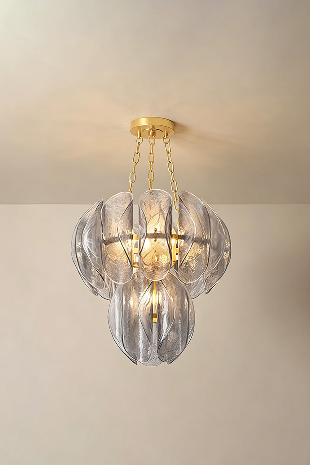 Ondine Cascading Leaf Glass Chandelier | Textured Smoked Glass and Gold Metal | Standard perspective view showcasing the glowing multi-layered leaf arrangement against a warm neutral wall | vexa lamps