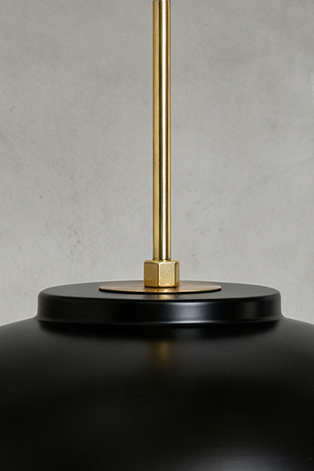 Close-up of the Adelaide Saucer Brass Pendant Light showcasing its metal structure and elegant design.