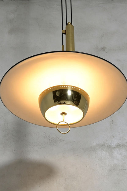 Adelaide Saucer Brass Pendant Light featuring a sleek design and high-quality metal structure with an elegant acrylic shade.