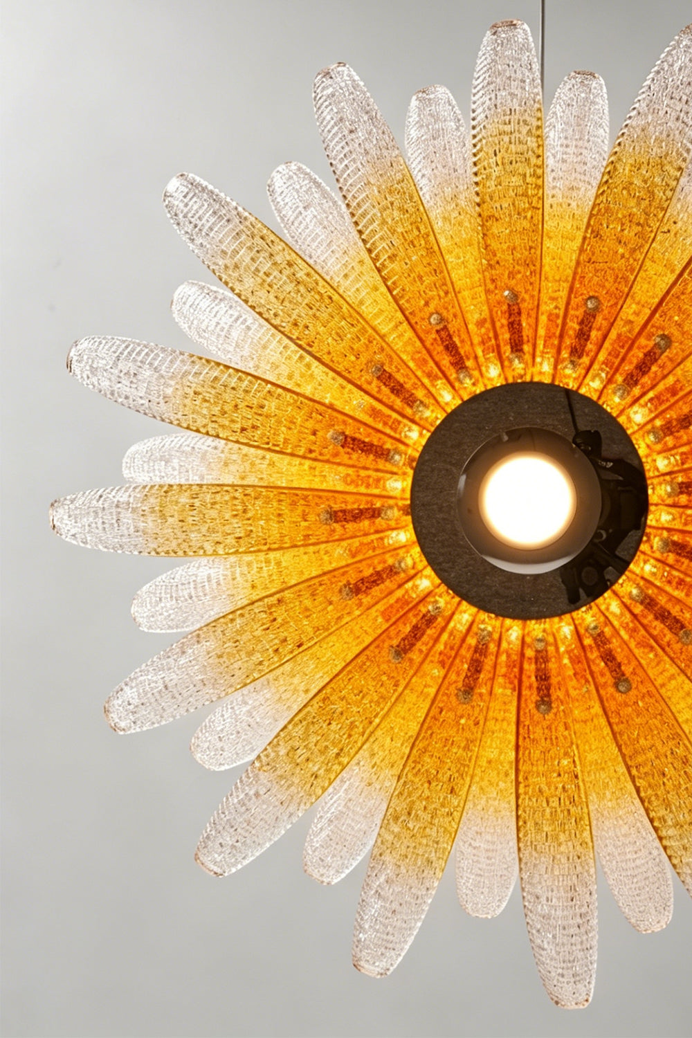 Helios Agave Glass Starburst Chandelier | Glass, Metal | Looking directly up at the fully lit chandelier, showing the warm amber gradient spreading from the center | Detail shot | vexa lamps