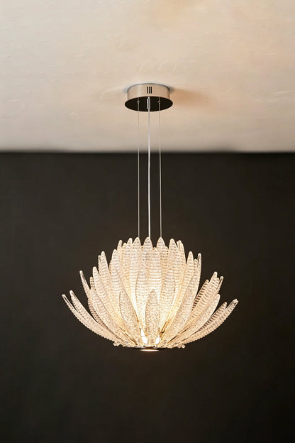 Helios Agave Glass Starburst Chandelier | Glass, Metal | Clear glass variant fully lit against a black background, highlighting its brilliant white light | Isolated shot | vexa lamps
