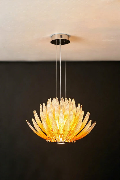 Helios Agave Glass Starburst Chandelier | Glass, Metal | Amber glass variant fully lit against a black background, creating a fiery warm glow | Isolated shot | vexa lamps