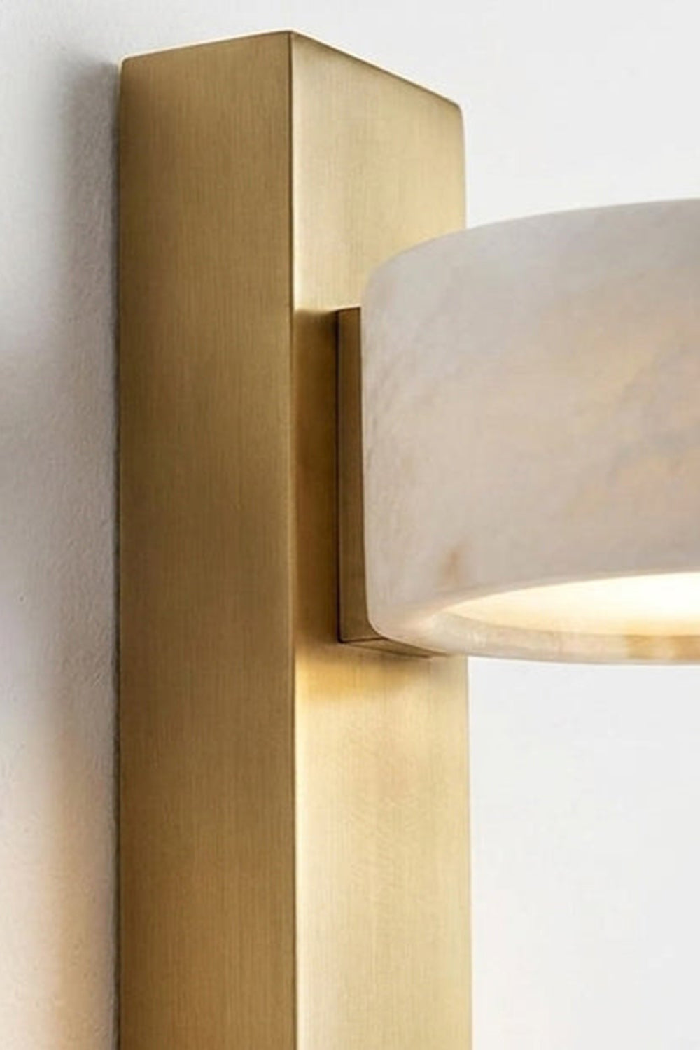 Alaric Alabaster Bar Wall Sconce | Natural Alabaster and Brass | Side perspective close-up view showcasing the thickness of the vertical brass rectangular bar and stone attachment | vexa lamps