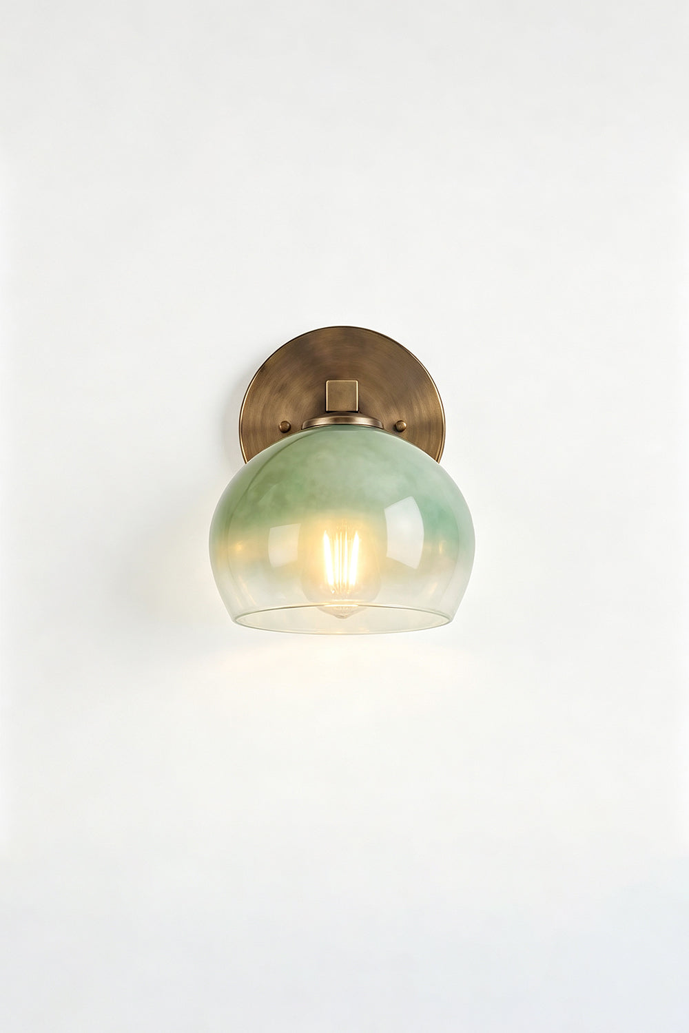 Alba Ombre Glass Wall Sconce with green glass globe and brass backplate, ideal for bathroom or entryway lighting.