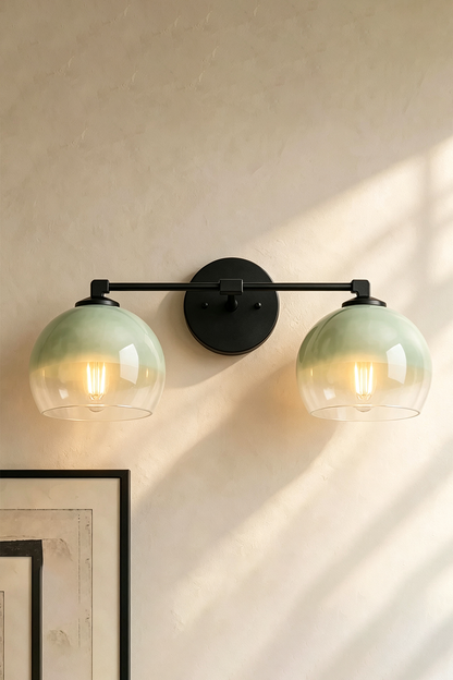 Alba Ombre Glass Wall Sconce featuring hand-blown green to clear glass globes on a sleek iron bar.