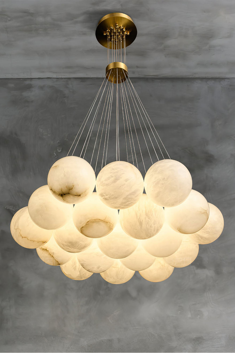 Amandine Alabaster Globe Cluster Pendant Light illuminating a stylish modern dining space.
