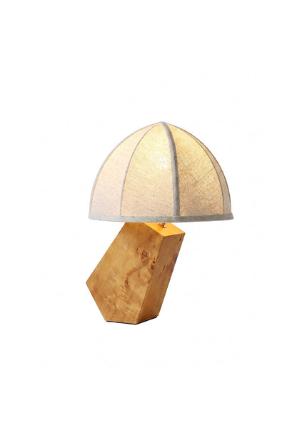 Angolo Canted Faceted Wood Table Lamp | Wood, Fabric, Metal | Table lamp featuring a paneled fabric dome shade and a sculptural faceted wood block base | Isolated lit product shot on white background | vexa lamps