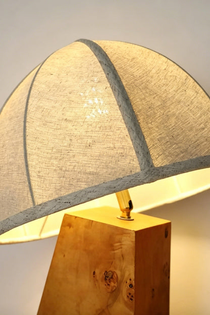 Angolo Canted Faceted Wood Table Lamp | Wood, Fabric, Metal | Close-up view showing the junction between the fabric dome shade and the faceted wood base | Detail shot | vexa lamps