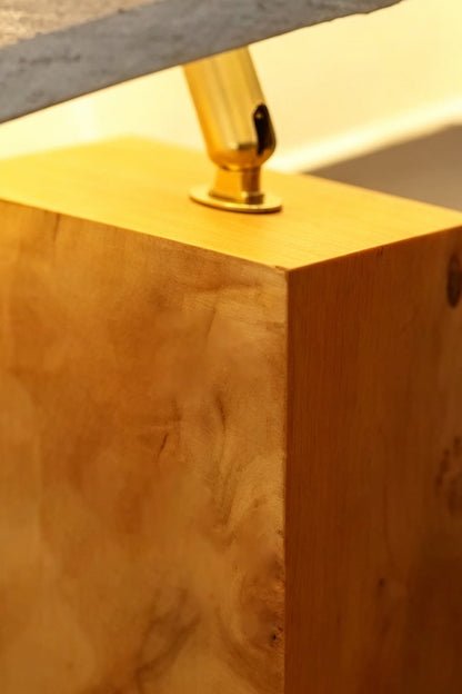 Angolo Canted Faceted Wood Table Lamp | Wood, Fabric, Metal | Close-up focus on the gold metal joint connector and the rich grain texture of the wood block base | Detail shot | vexa lamps