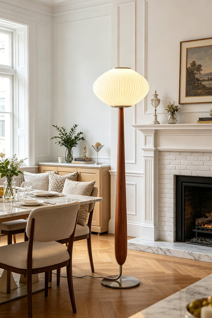 Arden Walnut Floor Lamp | Wood, Metal, Fabric | Standing as a warm accent light in a bright classical dining and living room corner near a fireplace and dining table setup | vexa lamps