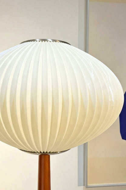 Arden Walnut Floor Lamp | Wood, Metal, Fabric | Close-up focus on the illuminated white ribbed pleated saucer lampshade showcasing the soft light diffusion and texture | Detail shot | vexa lamps