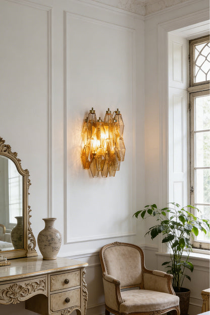 Amber Art Poliedri glass wall sconce providing warm glow | Metal, Glass | Traditional room setting with vanity mirror and chair | vexa lamps