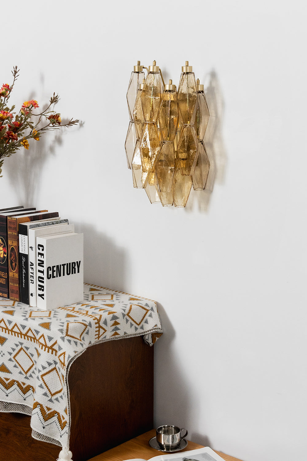 Unlit amber polyhedral glass wall lamp | Metal, Glass | Side perspective view above a decorative console | vexa lamps