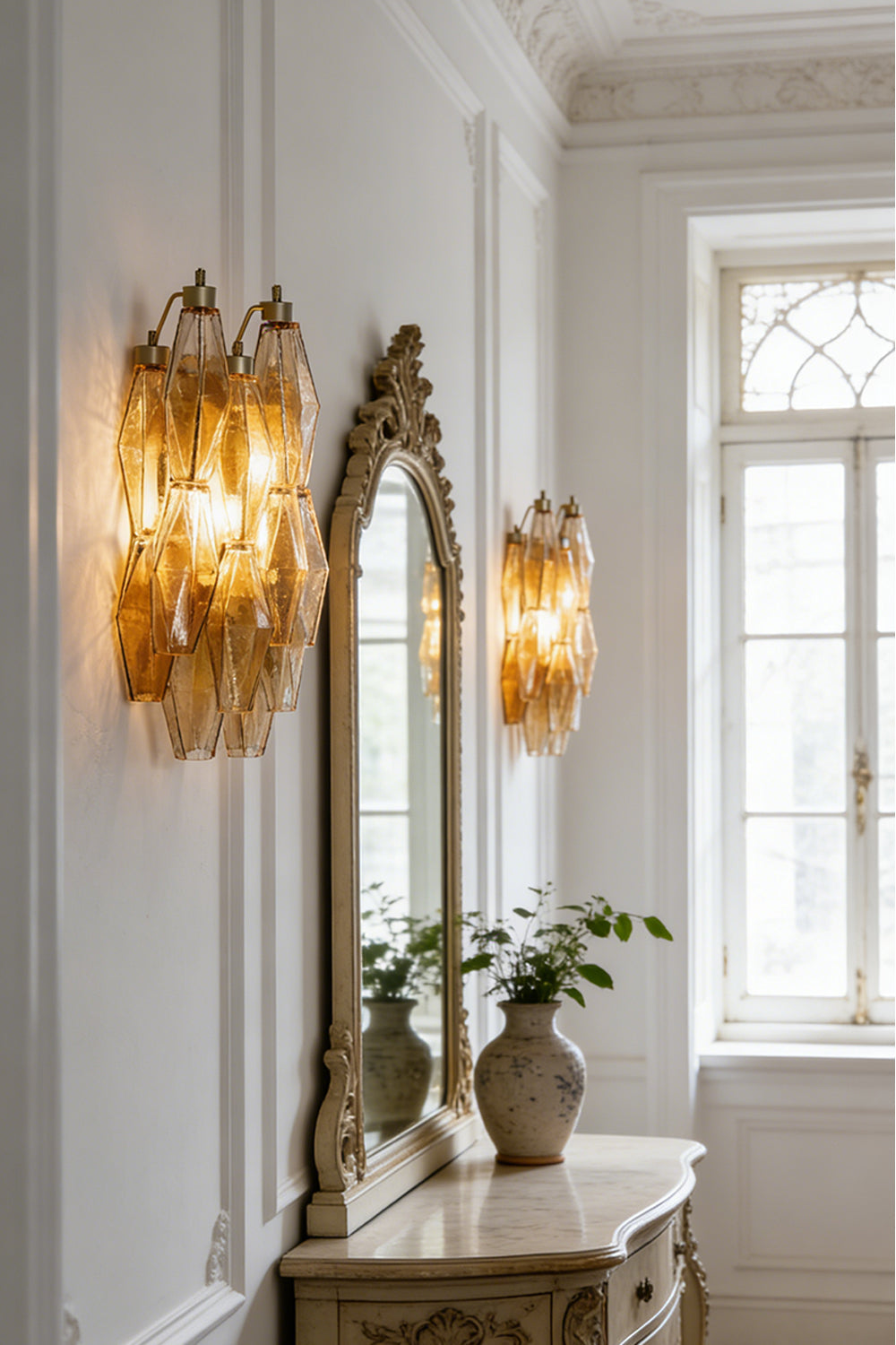 Pair of amber glass wall sconces | Metal, Glass | Symmetrical installation flanking a mirror in a bright room | vexa lamps