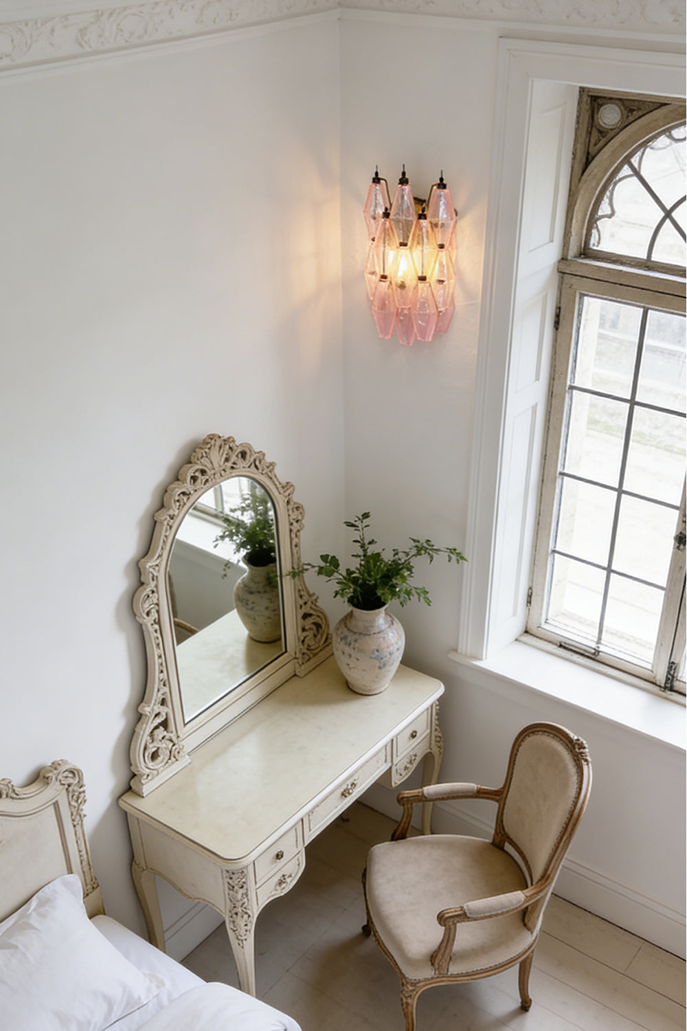 Lit pink glass wall sconce | Metal, Glass | Mounted in a classic dressing room above a desk | vexa lamps