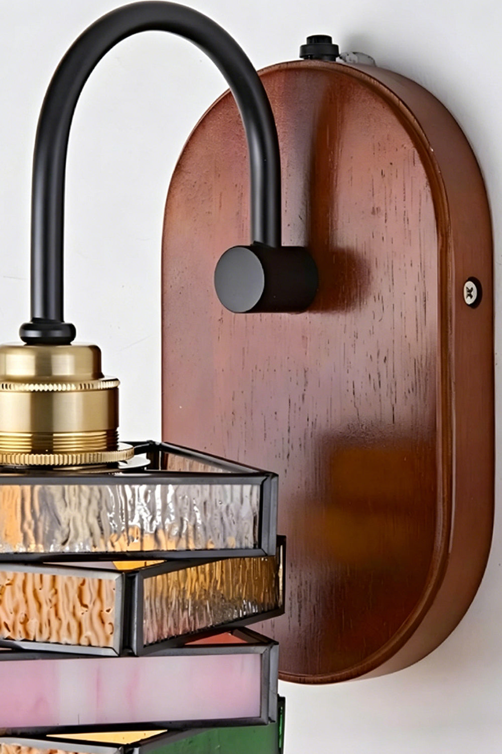 Artisan Mosaic Stained Glass Wall Sconce with dark iron arm and wooden mount detail.