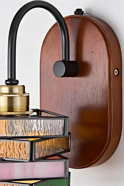 Artisan Mosaic Stained Glass Wall Sconce with dark iron arm and wooden mount detail.