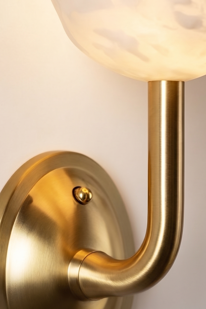 Ascendant Wall Lamp hardware detail | Brass | Close-up of polished brass base and curved arm | vexa lamps