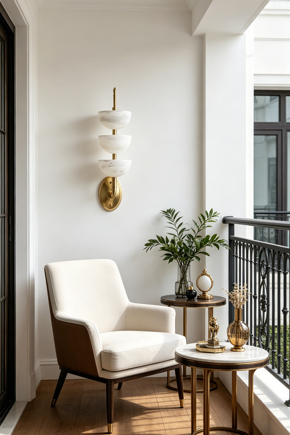 Ascendant Wall Lamp on balcony | Alabaster, Brass | Sunlit white wall next to comfortable armchair | vexa lamps