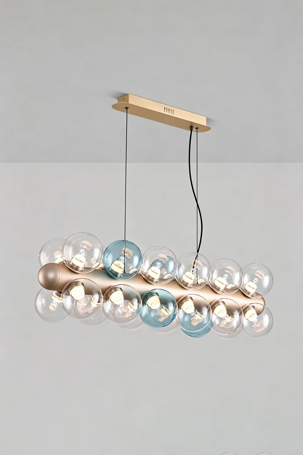 Astraea Linear Prismatic Globe Chandelier with hand-blown glass spheres in brushed champagne-gold finish.