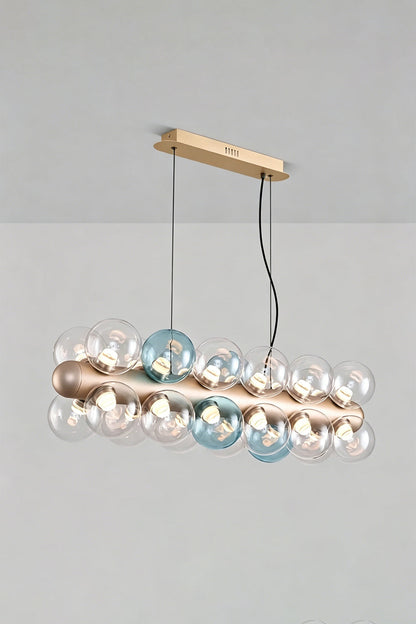 Astraea Linear Prismatic Globe Chandelier with hand-blown glass spheres in brushed champagne-gold finish.