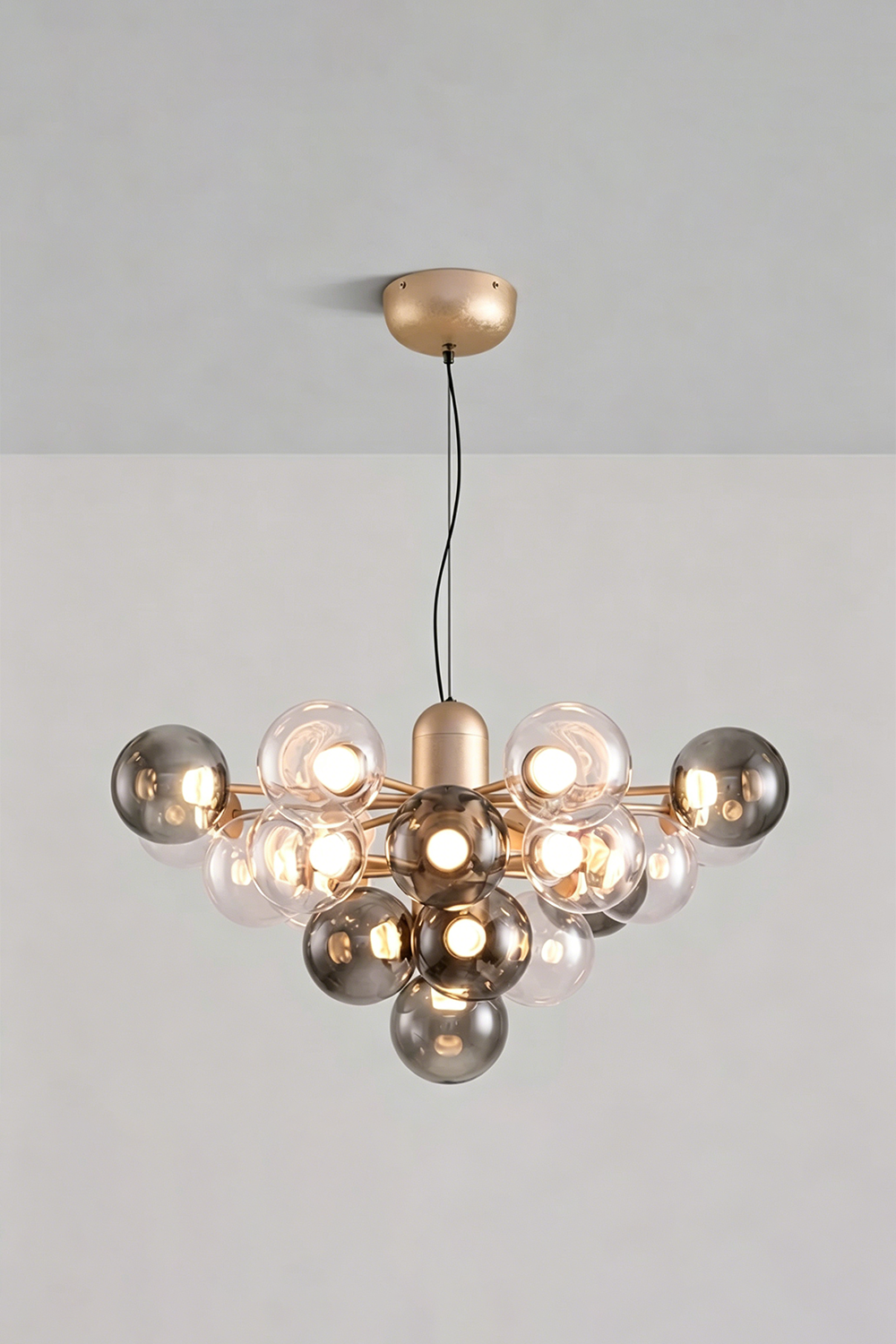 Astraea Prismatic Globe Chandelier | Glass, Metal | Studio view of the smoky mirror grey glass bubble variant fully illuminated against a plain grey backdrop | vexa lamps