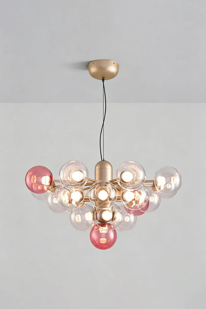 Astraea Prismatic Globe Chandelier | Glass, Metal | Studio view of the romantic rose pink glass bubble variant fully lit against a plain grey background | vexa lamps