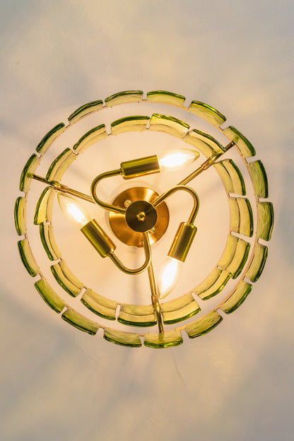 Aura Verdant Tiered Green Glass Ceiling Light | Metal, Glass | Looking directly up at the illuminated ceiling light, showing the symmetrical three-bulb structure | Detail shot | vexa lamps