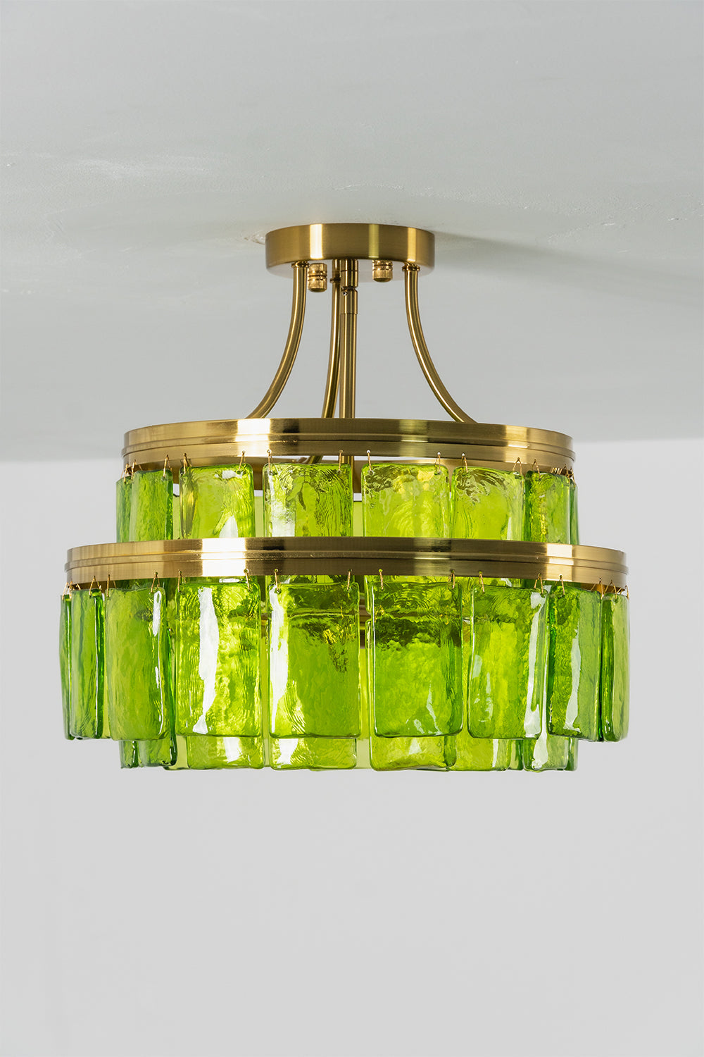 Aura Verdant Tiered Green Glass Ceiling Light | Metal, Glass | Frontal view of the unlit green glass tiered ceiling light against a neutral grey studio background | Isolated shot | vexa lamps