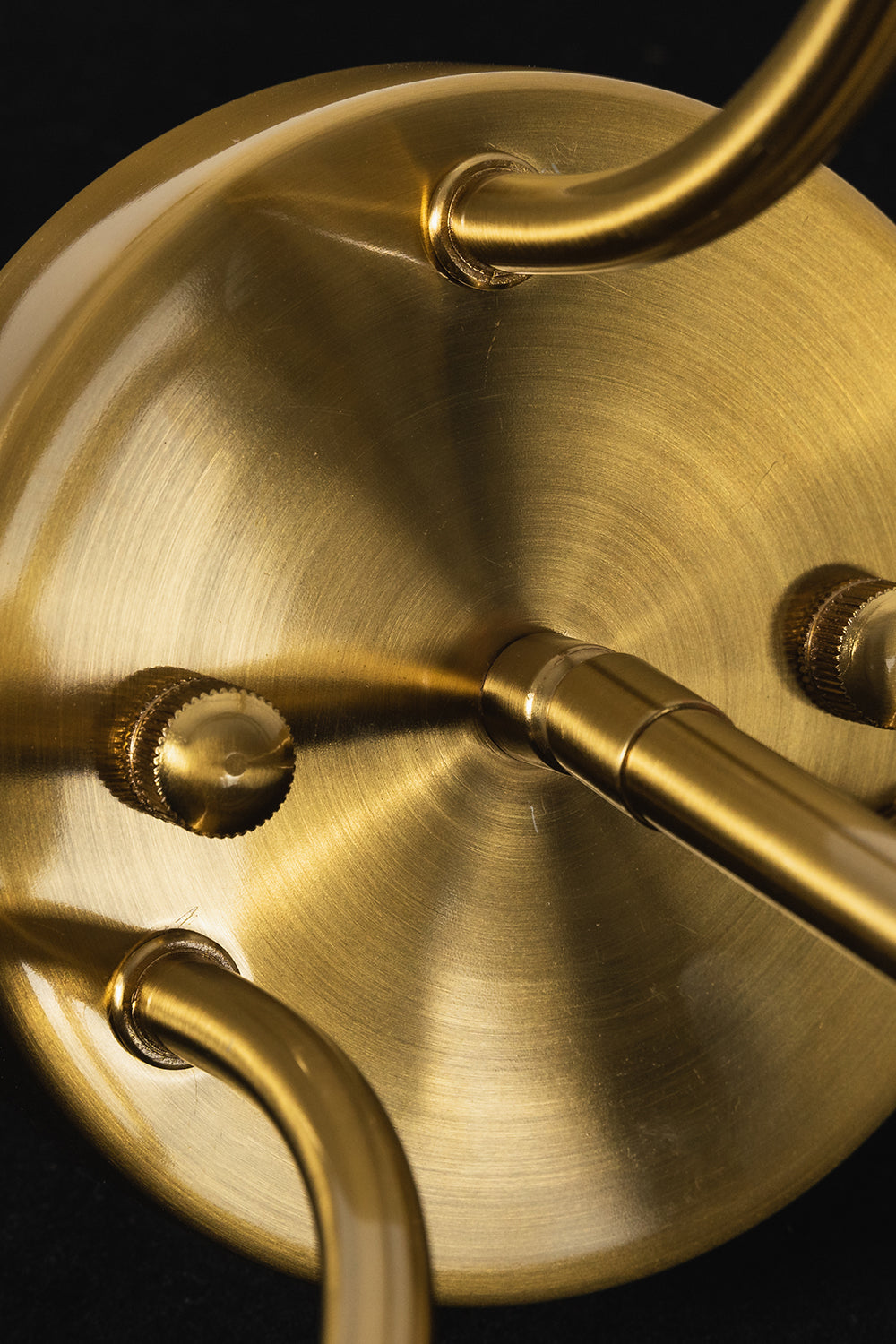 Aura Verdant Tiered Green Glass Ceiling Light | Metal, Glass | Macro focus on the brushed brass ceiling canopy and the curving metal support arms | Detail shot | vexa lamps