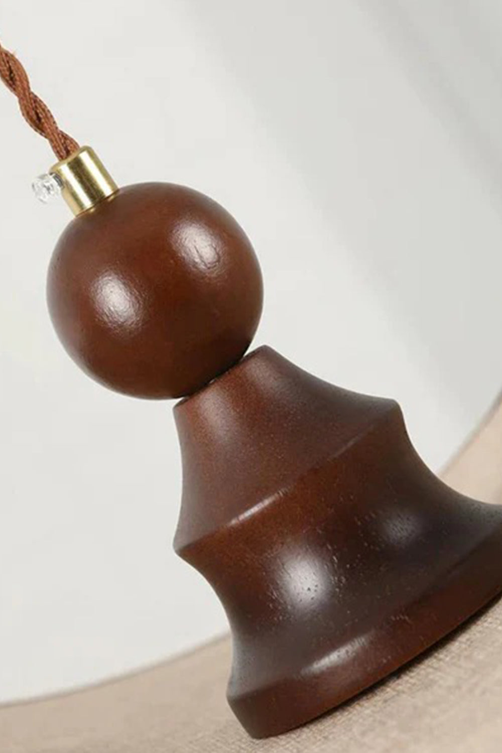 Aurelia Blossom Glass Pendant Light | Wood, Fabric, Glass | Close-up view of the decorative dark turned wood bead finial and brass hardware connecting the shade to the braided cord | Detail shot | vexa lamps