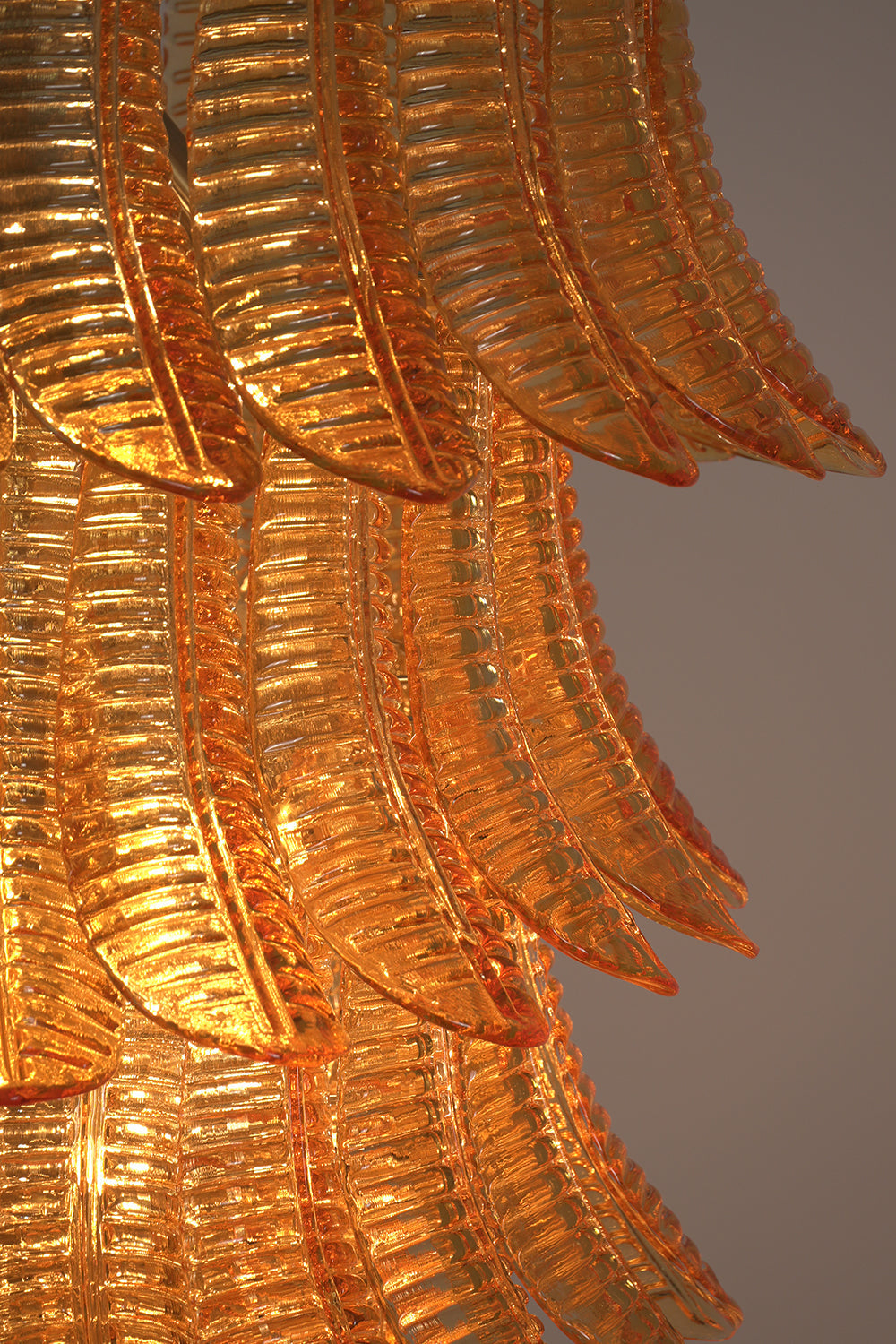 Aurelia Helix Amber Glass Cascade Chandelier showcasing intricate amber-hued glass plumes in a stunning spiral design.