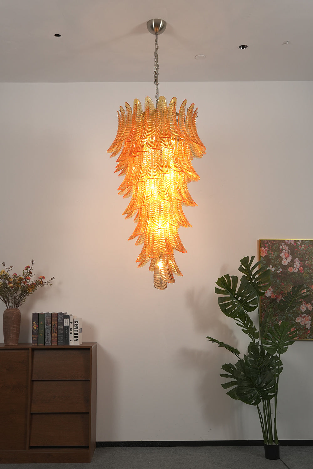 Aurelia Helix Amber Glass Cascade Chandelier hanging elegantly in a stylish interior setting, showcasing amber glass plumes.