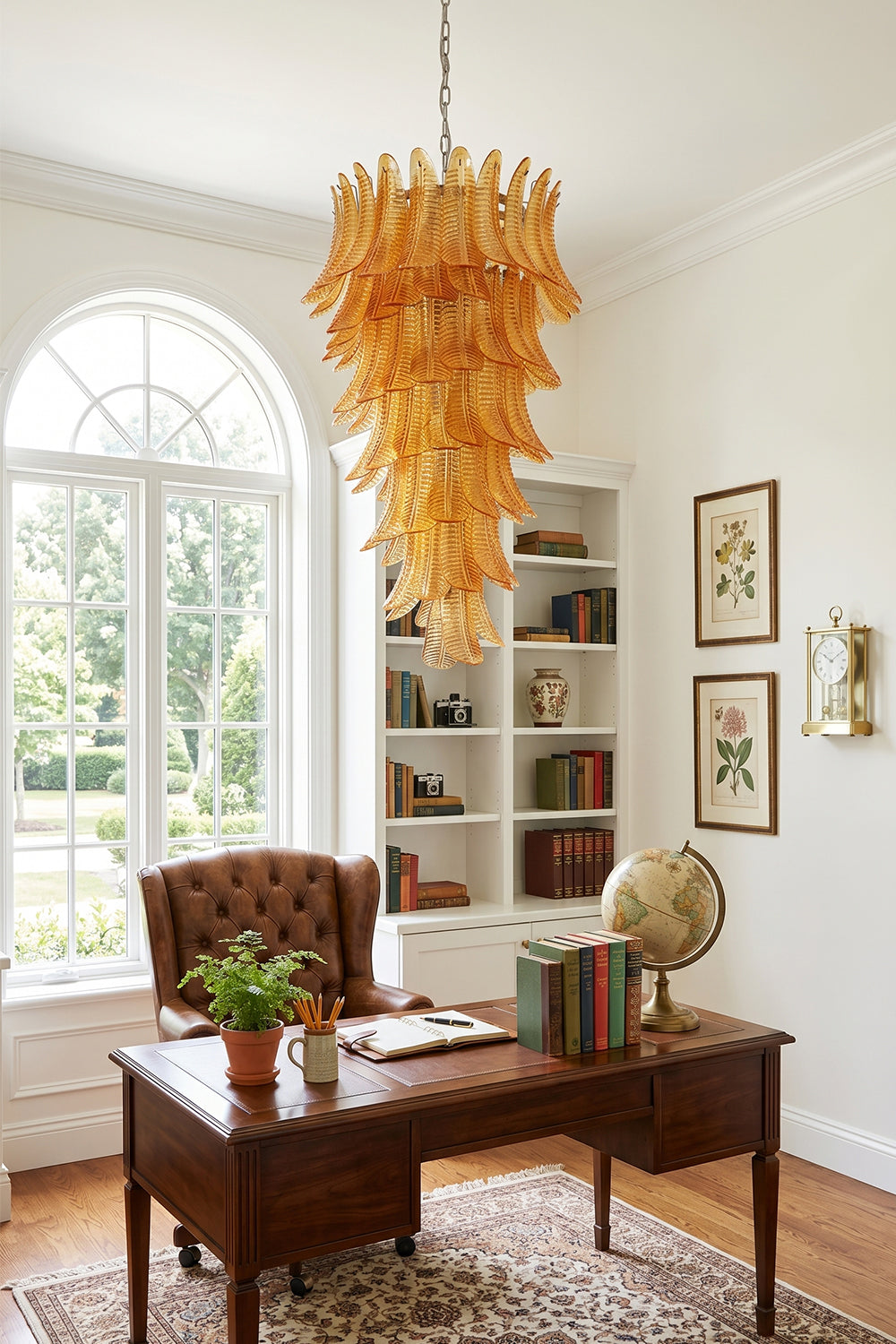 Aurelia Helix Amber Glass Cascade Chandelier hanging in a stylish home office beside a vintage desk and bookshelves.