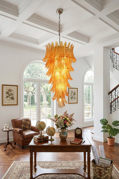 Aurelia Helix Amber Glass Cascade Chandelier illuminating a stylish foyer with elegant decor.