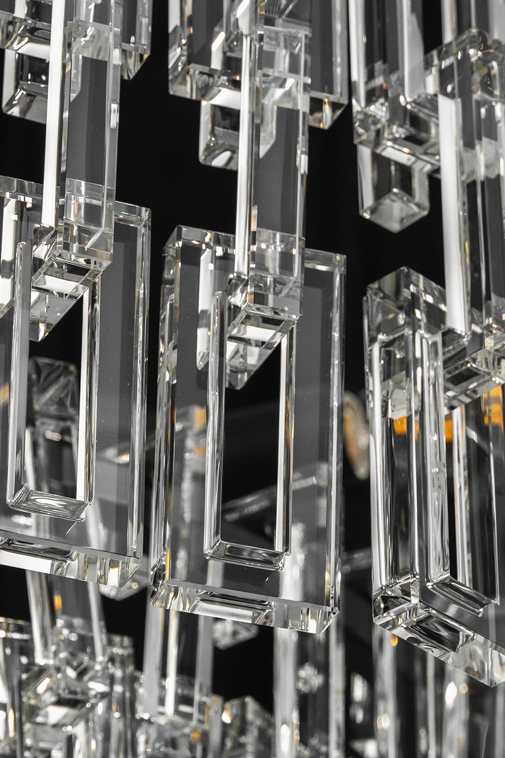 Aven Tiered Glass Prism Chandelier | Glass, Metal | Extreme close-up highlighting the interlocking rectangular clear glass link prisms hooked onto the frame | Detail shot | vexa lamps