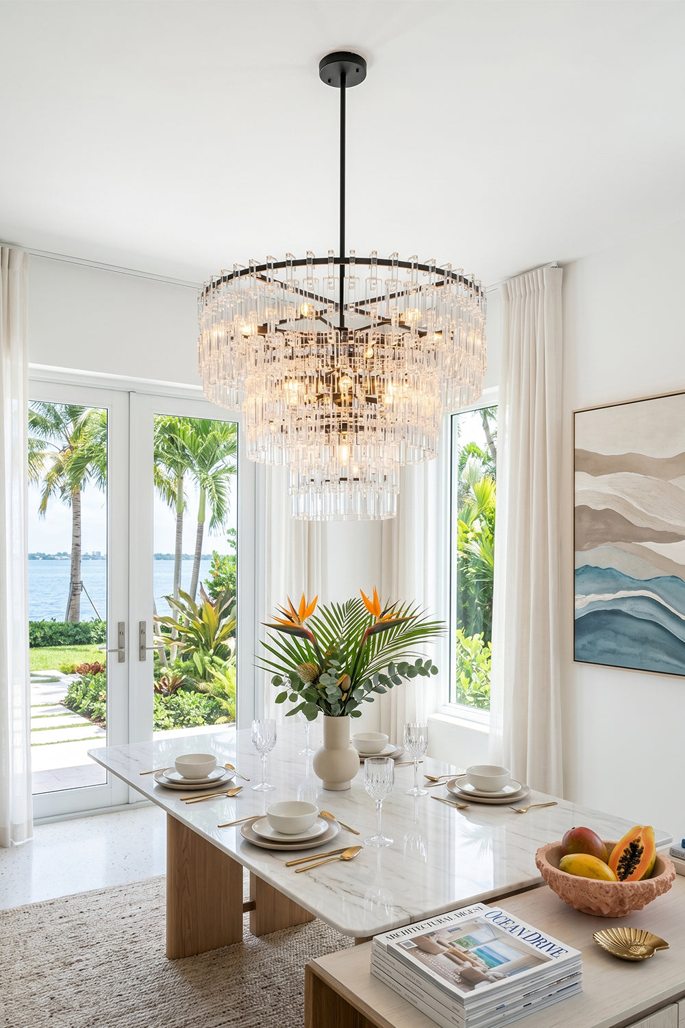 Aven Tiered Glass Prism Chandelier | Glass, Metal | Providing elegant ambient lighting over a contemporary marble dining setup with open sliding doors to a beach view | vexa lamps