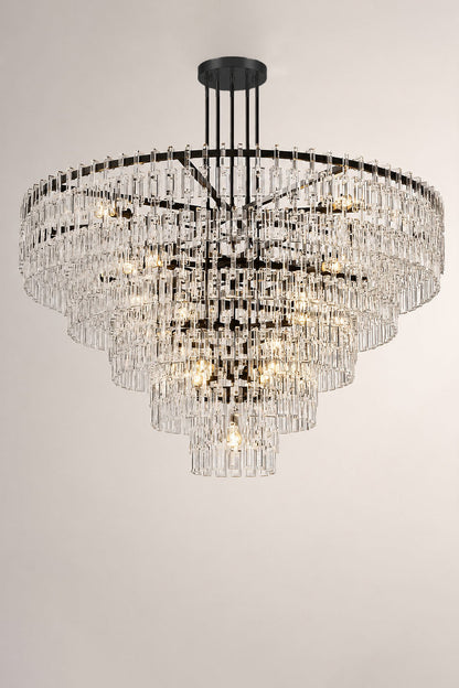 Aven Tiered Glass Prism Chandelier | Glass, Metal | Minimalist mockup shot of the unlit black metal and clear glass tiered chandelier centered against a grey wall | vexa lamps