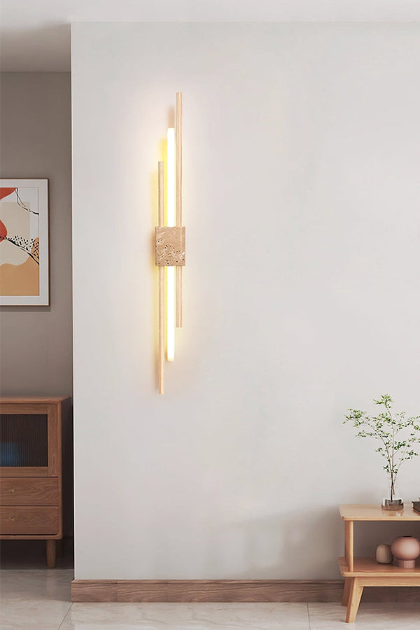 Axis Terra wall sconce in a minimalist living area | Travertine, Metal, Glass | Mounted on a plain white wall | vexa lamps