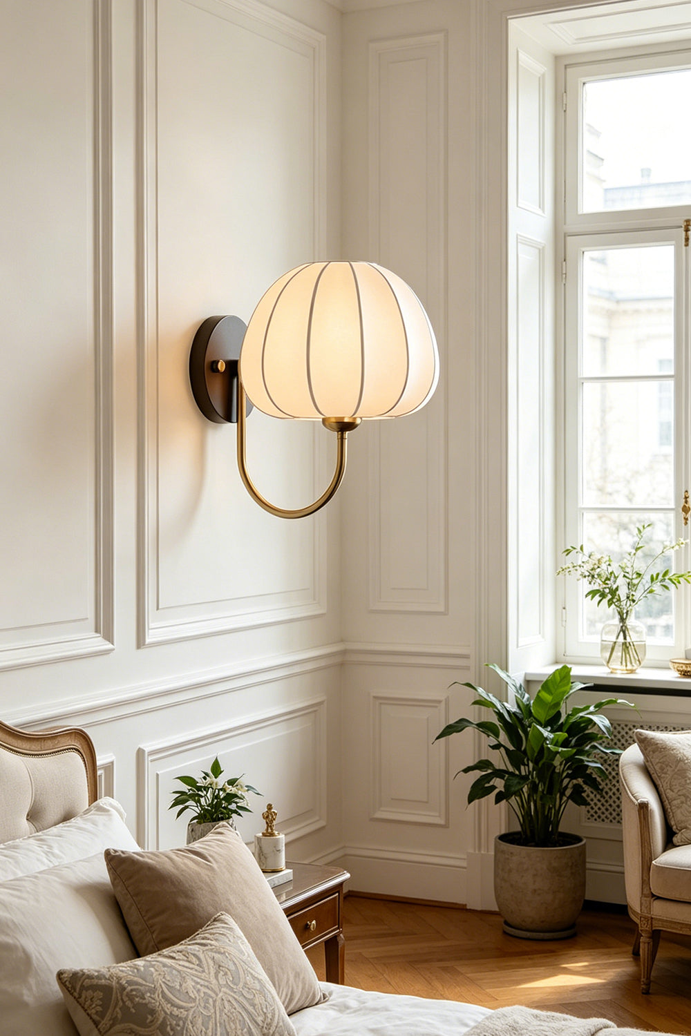 Baird Mid Century Pumpkin Wall Lamp | Metal, Fabric, Wood | Wall-mounted above a cozy lounge area with pillows and indoor plants in a classically decorated room | vexa lamps