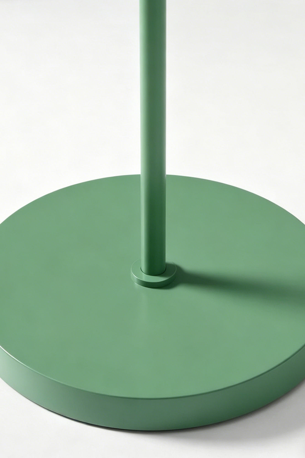 Floor lamp base detail | Metal | Close-up of circular green metal base and stem | Matte finish texture | vexa lamps