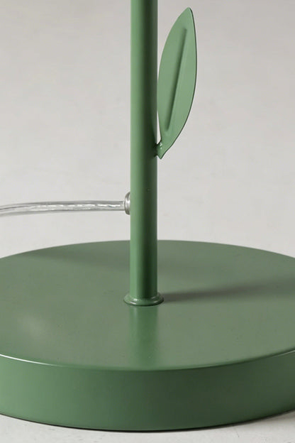 Base and stem close-up detail | Metal | Red/Yellow petal botanical lamp | Circular green base, stem, leaf detail | Power cord visible | vexa lamps