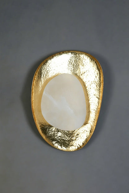 Caeliform Aurelia Alabaster Wall Lamp | Alabaster, Brass | The lamp mounted on a dark grey, textured feature wall for a dramatic, moody contrast | Isolated product shot | vexa lamps
