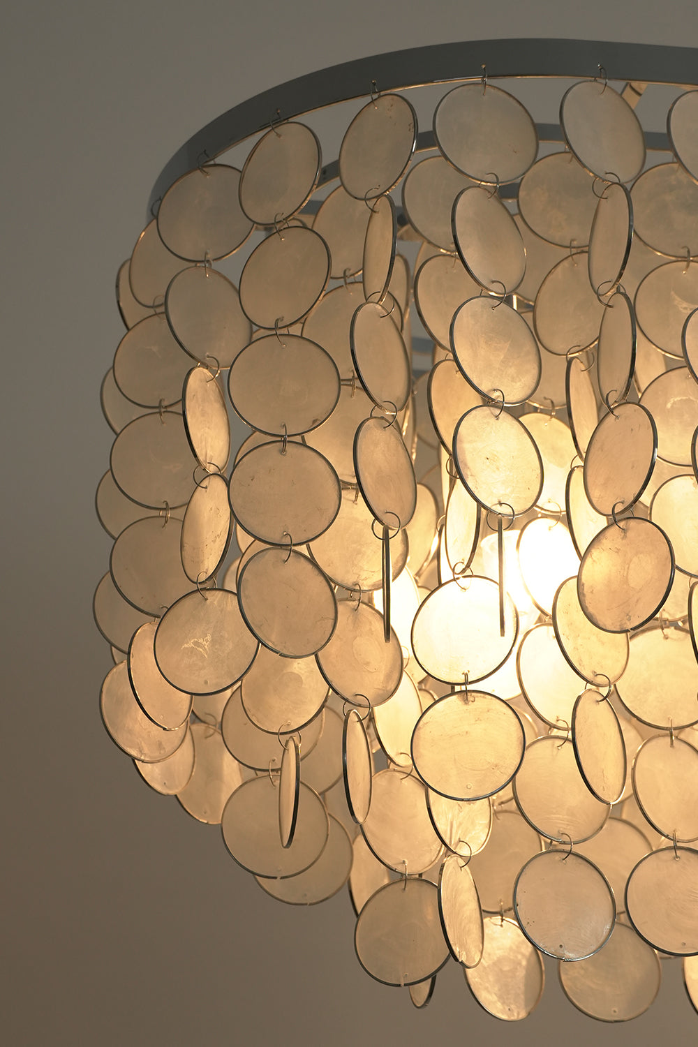 Corner detail of shell chandelier frame | Iron | Shell | Close-up of the chrome hardware and cascading shell panels | vexa lamps