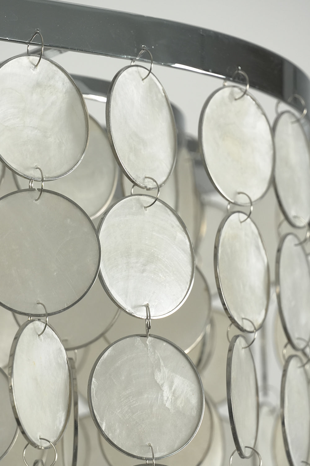 Cascading shell discs on metal frame | Iron | Shell | Side profile showing the texture and layering of the chandelier | vexa lamps