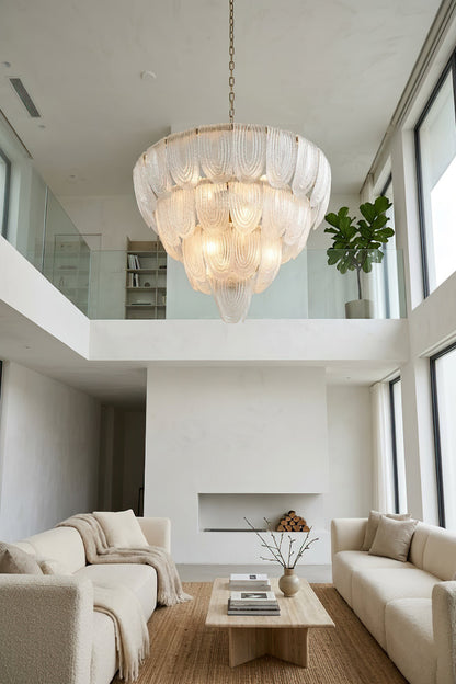Tiered glass petal pendant lamp in spacious interior | Metal, Glass | Living room scene with large windows and white sofas | vexa lamps
