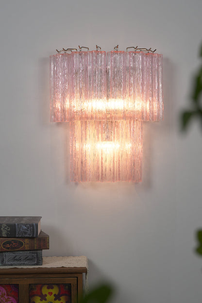 Cascading Prism Pink Glass Wall Light | Glass, Metal | Front view of the fully lit pink glass lamp creating a warm, soft glow | Isolated shot | vexa lamps Cascading Prism