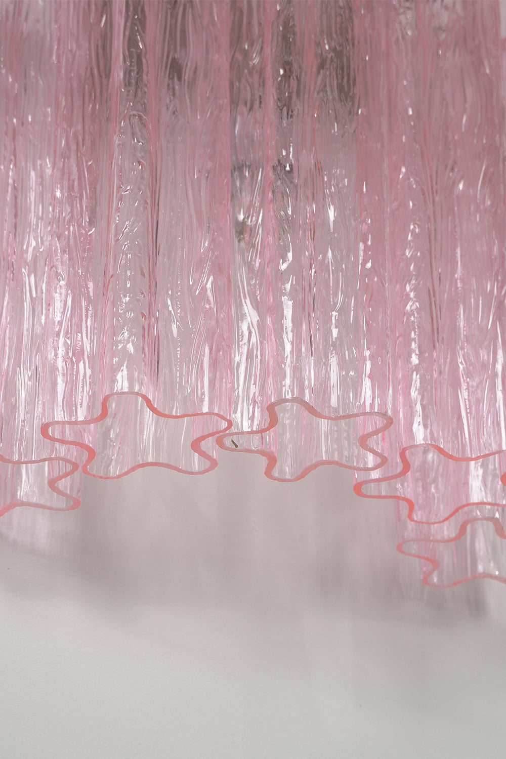 Cascading Prism Pink Glass Wall Light | Glass, Metal | Macro view of the delicate wavy bottom edges of the pink glass elements | Detail shot | vexa lamps Cascading Prism